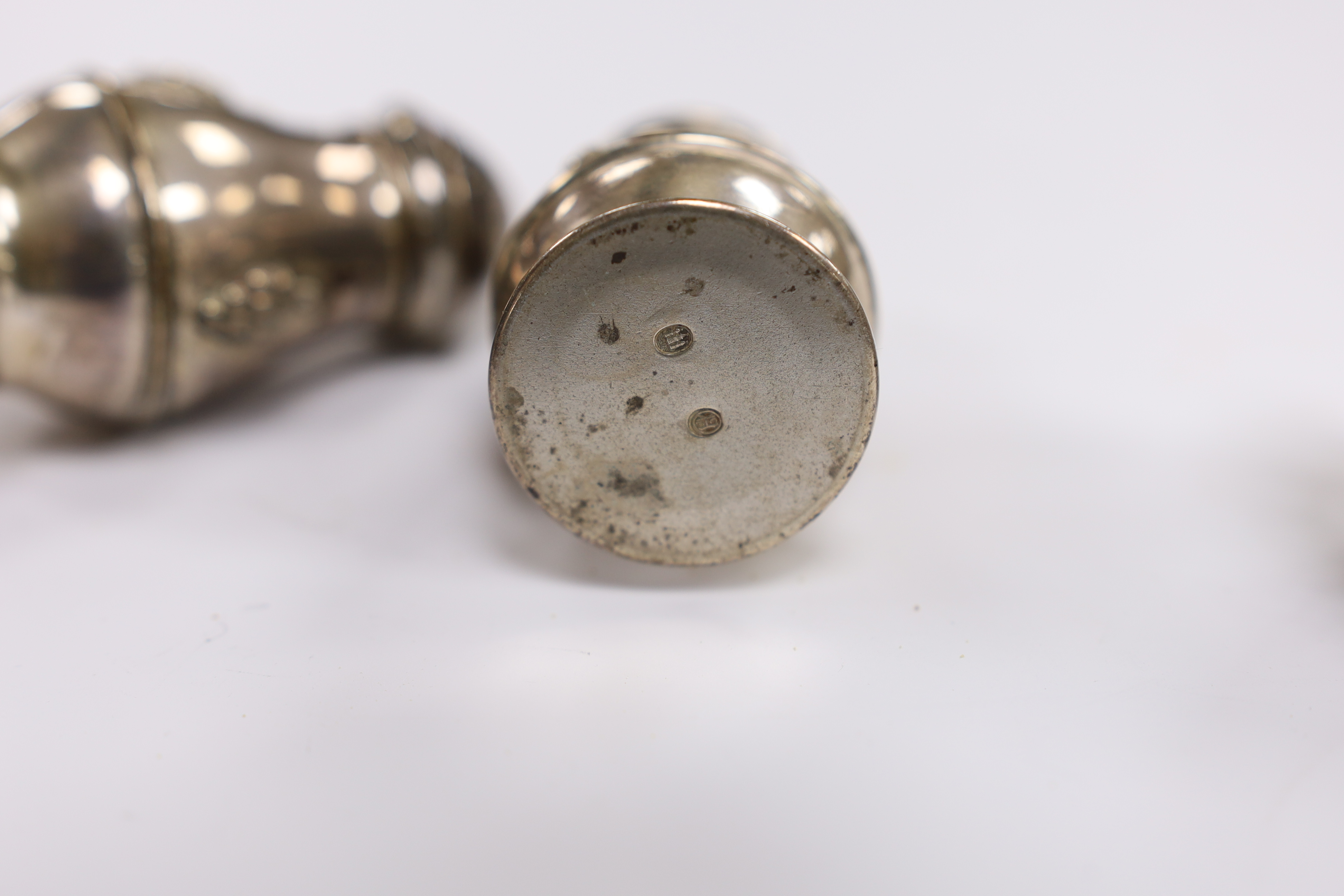 A Danish 830 white metal sifter spoon and tea strainer, by Evald Nielsen and a pair of 1930's Danish white metal condiments.